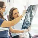 woman and dentist examine x-rays