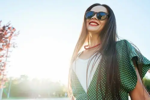 woman smiles in the sunshine