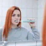 woman brushing teeth