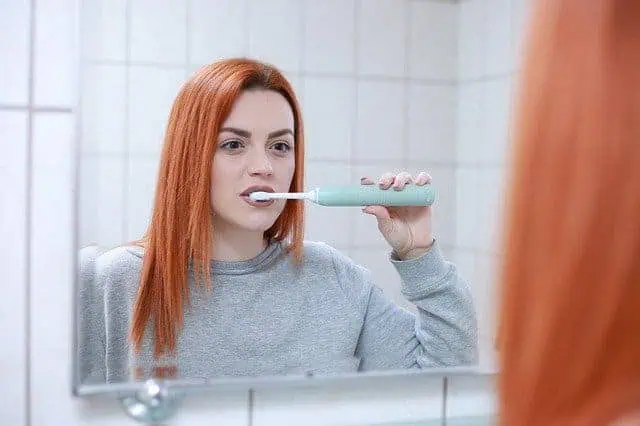 woman brushing teeth