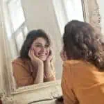 woman smiling in mirror