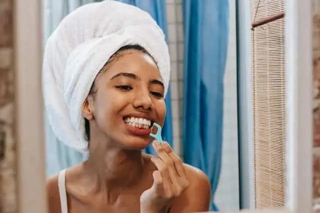 woman flossing her teeth